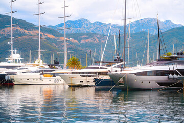 Yachts docked near waterfront apartments.