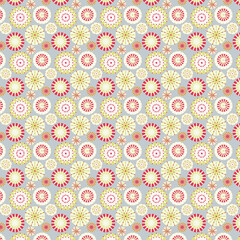 Retro seamless circle pattern with bright floral sunbursts in red, green, and yellow on gray, great for playful textiles, mid-century decor, and fun surface design.