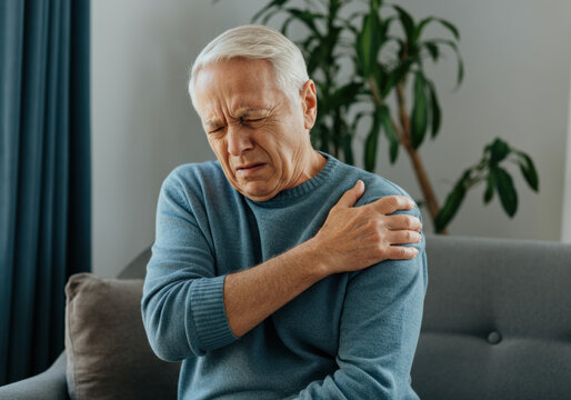 Elderly Man Experiencing Shoulder Pain - Powered by Adobe
