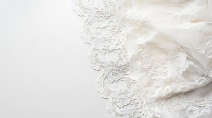 Obraz premium Elegant White Lace Fabric Draped on White Background