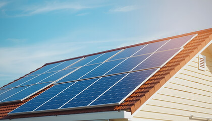 Obraz premium Solar panels on the roof of a private house on blue sky background, smooth light, with white tones