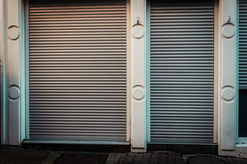 Closed shopfront in a quiet urban street illuminated by evening light