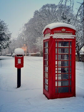 Postbox and phone box in the snow 