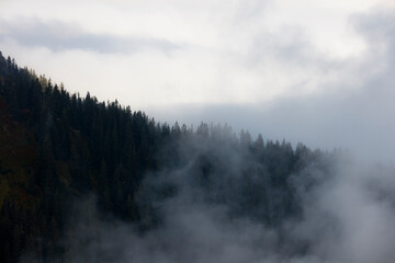 Scenic view of misty mountains in Saalbach Hinterglemm, Austria, capturing the serene beauty of...