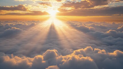 Brilliant sun beams shine down through thick layers of clouds from the bright upper sky.