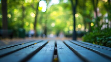Fototapeta premium Wooden Table in Nature with Blurred Green Background Ideal for Technology and Nature Themes