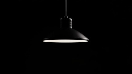 Elegant black pendant lamp casting soft dim light against a dark backdrop creating a modern ambiance for interior design concepts