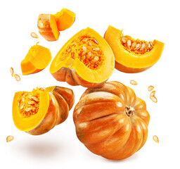 Orange round pumpkins, pumpkin slices with pumpkin seeds falling down on white background.