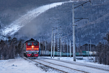 Train locomotive pulls wagons with cargo.  Transportation industry