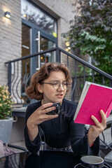 A young woman is carefully reading a book. Emotion concept.