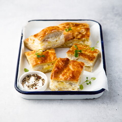 Savory potato pie with cheese and ham