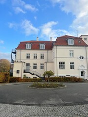 White houses with a red roof in the town, Colorful golden sunset sky calmness tranquil relaxing sunlight summer vibes. Park like private garden. Path in the forest. Skive