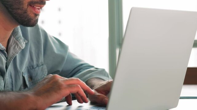Close up cropped view male hands typing on laptop keyboard sit at workplace desk, web surf information, browse wireless internet, scroll news feed, answers on e-mail, messaging, communicates remotely