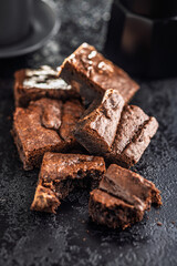 Homemade chocolate brownies on black table.