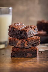 Homemade chocolate brownies on wooden table.