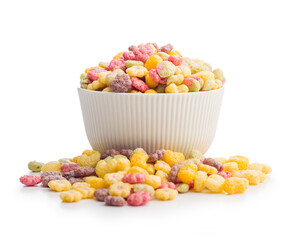 Colorful breakfast cereals in the shape of various fruit in bowl isolated on white background.