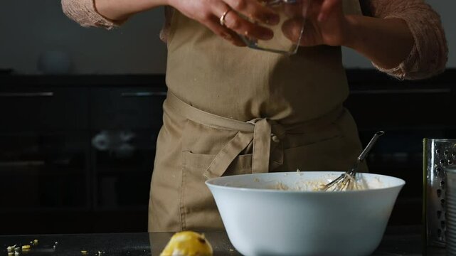 Person Preparing Easter Recipe with Lemon Zest and Ingredients in the Kitchen
