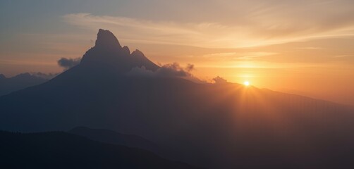 Majestic mountain at sunrise with soft rays