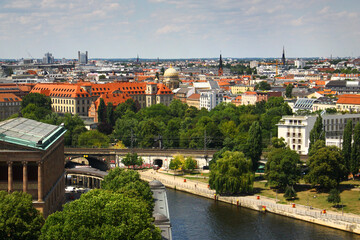 Berlin, Germany - July 9, 2024: View of central Berlin from the Berlin Cathedral, with Museum Island, the Spree River, and iconic city landmarks under a clear summer sky.