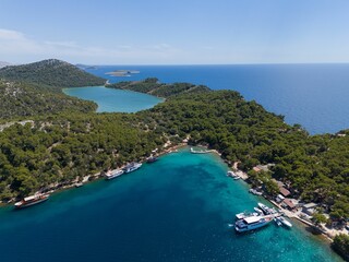 Fototapeta premium Aerial view of lush greenery and clear blue waters in Telascica Nature Park, Croatia
