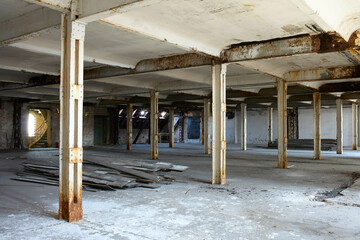 Abandoned industrial building interior with columns and scattered debris, Berlin, Germany