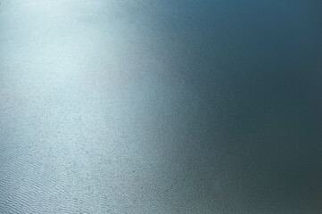 Tranquil blue water surface with gentle ripples reflecting sunlight. seen from an airplane near New Orleans, USA