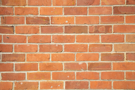 Fototapeta Orange brick wall with a classic staggered pattern and visible mortar joints, Auckland, New Zealand