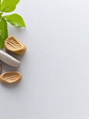 Serene leaf shaped stones rest gently on a bright white background creating a calming spa aesthetic. AI Generated