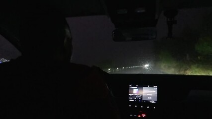 Driver and Windshield view, Car Driving at night on a rainy storm