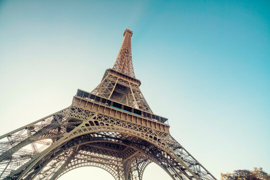 Eiffel Tower reaching into the clear sky at sunset, Paris, France