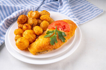 Breaded chicken cutlet with whole fried baby potato side