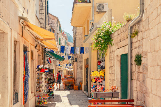 Narrow cobblestone alley with medievval historic houses in summer in Omis, Croatia