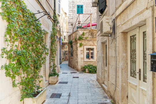 narrow street in the historic old city of Split with medieval bricks buildings in summer, Croatia - Powered by Adobe