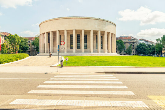 Circular modern building  of Croatian Association of Fine Artists with columns in an urban green space under a blue sky, Zagreb, Croatia