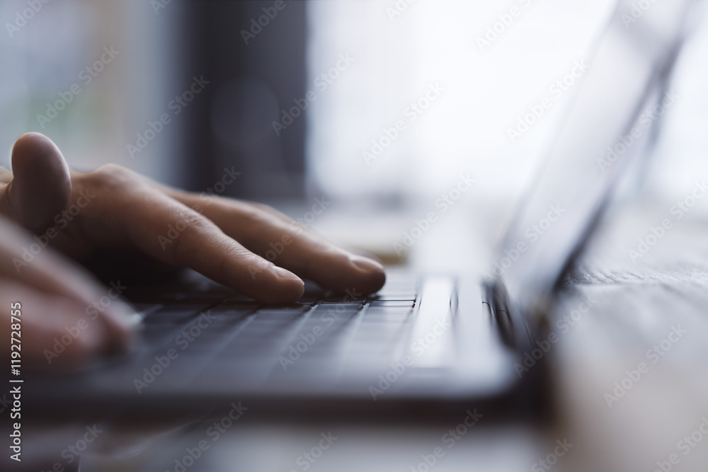 Poster a man's hands are captured up close, busily typing on a sleek laptop keyboard, set against a fuzzy o