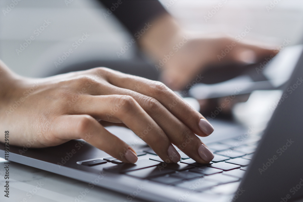 Poster a close view of a woman's hands typing on a modern laptop keyboard, office surroundings appearing fu
