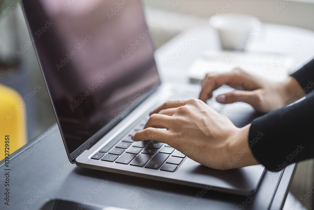 Poster with a blurred office environment in the backdrop, the image focuses on a woman's hands typing on a 