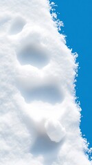 Bright blue sky contrasts sharply with pristine snow footprints. AI Generated