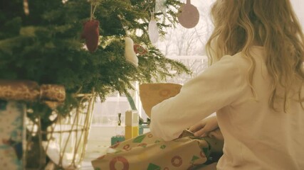 Sisters unwrap gifts for Christmas in the morning