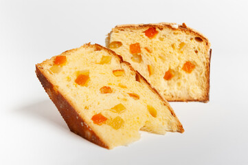 Slice of Panettone fruit cake with diced fruit pieces