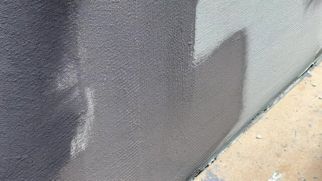 This process showcases the meticulous application of paint on a quartz wall, highlighting the technique and tools used for achieving a flawless result.