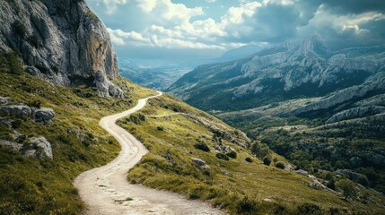 Obraz premium Scenic Winding Path Through Lush Green Valley Surrounded by Mountains