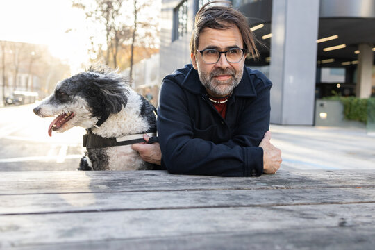 Man enjoying time with his dog in an urban setting