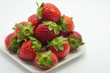 pile of fresh strawberries on a plate