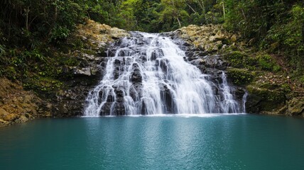 Obraz premium Serene Waterfall Cascading into Emerald Pool Lush Tropical Rainforest Landscape