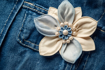 artificial flower on jeans and trousers