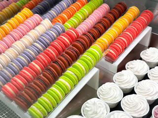 Rows of macarons of different colors. Sweet and colourful french macaroons. 