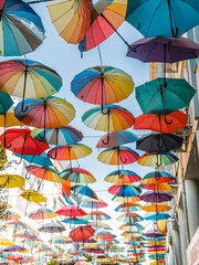 Colored umbrellas hanging between buildings. Decoration art of Colorful umbrella hanging, beautiful decoration for outdoor view and visitor. © irina