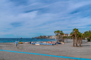 Almunecar beach Spain with palm trees and boats Costa del Sol Andalusia
