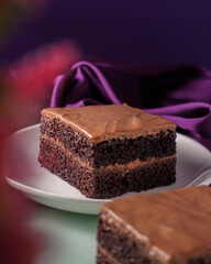 Chocolate cake pastry on the purple background